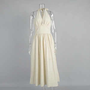 Detailed view of the V-neck pleated bodice and halter neck design on a beige midi dress