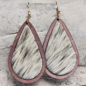 Macro view of teardrop wood earrings featuring leopard print faux fur texture details