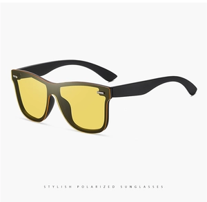 Detail of yellow polarized lenses and matte black frame on oversized sunglasses