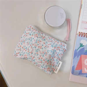 Detail of floral cotton coin purse with pink flower print and white zipper closure