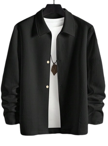 Detailed view of black jacket showing geometric textured fabric and lapel design
