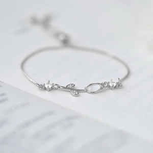 Elegant silver tulip bracelet with opal and zircon stones on a light grey background