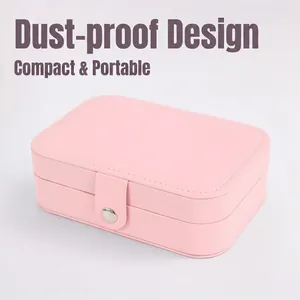 Compact pink portable jewelry organizer box with metal snap button and white stitching
