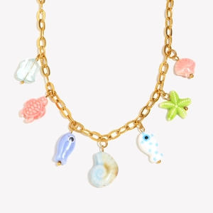 18K gold plated necklace with ocean-themed colorful ceramic fish and seashell pendants