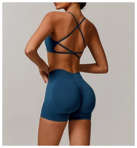 Detail of teal seamless yoga set showing cross-back bra and scrunch-butt gym shorts