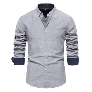 Detail of light grey slim fit shirt with contrast navy blue collar and cuffs texture