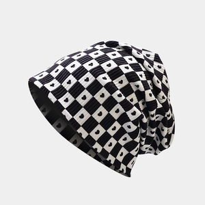 Close-up of checkerboard knit beanie with heart pattern and ribbed texture detail