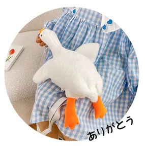 Close-up of cute white plush goose crossbody bag with adjustable strap and orange beak