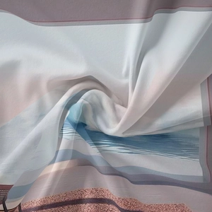 Detail showing the soft texture and beach landscape print of the lightweight fabric tapestry