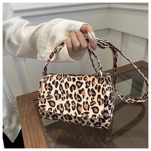 Close-up of leopard print crossbody bag with rectangular flap and sturdy canvas texture