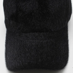 Detailed close-up showing the soft plush faux fur texture of the black baseball cap