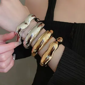 Minimalist irregular liquid metal bracelets set in polished gold and silver finish
