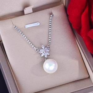 Elegant silver flower necklace with large round white pearl and sparkling crystals