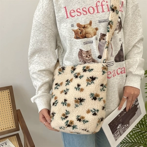 Detail of floral plush shoulder bag made of soft faux lamb wool on a casual model