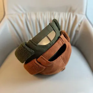 Detail view of adjustable back straps on dark green and yellow cotton brimless docker caps