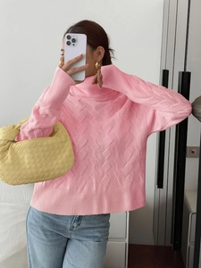 Women's pink turtleneck sweater with wave knit texture and loose fit casual style