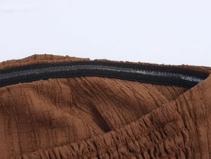Close-up of the black silicone anti-slip strip inside the brown strapless vacation top