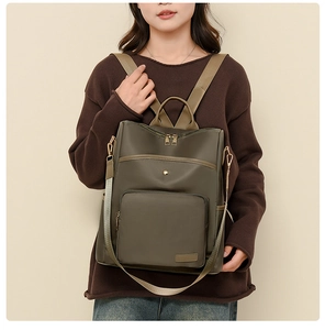 Close-up of olive green oxford backpack featuring water-resistant fabric and leather trim