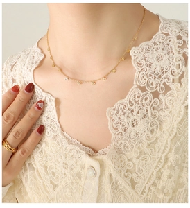 Detail of 18k gold plated choker featuring delicate evil eye charms and matching rings