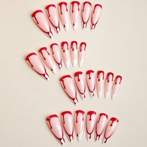 Long stiletto press-on nails with white French tips and red blood drip Halloween design