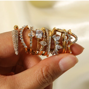 Macro shot of gold-plated titanium rings set with sparkling cubic zirconia on silk