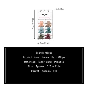 Set of six butterfly mini hair clips in various Morandi colors on a white display card