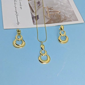 Gold stainless steel jewelry set featuring triple layered teardrop pendant and earrings
