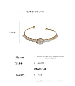 Detail view of gold open bangle showing dimensions 5.8cm and cubic zirconia inlay
