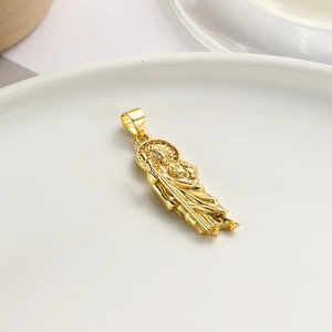 Gold oval pendant with religious relief and zircons on white ceramic plate