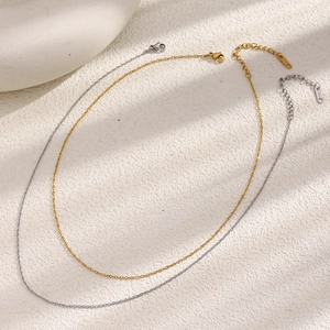 Detail of 1.4mm stainless steel cross chain necklaces in gold and silver finishes