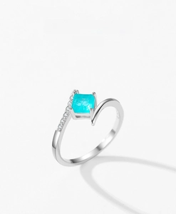 Detailed macro of S925 silver ring featuring square blue gemstone and bypass accent