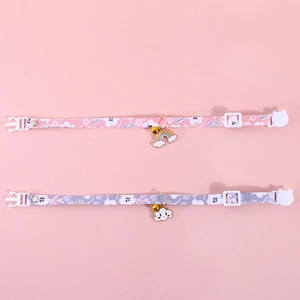Detail of adjustable pet collars with floral patterns, enamel pendants, and bells