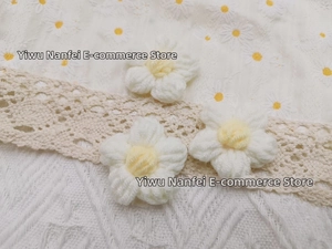 Detailed macro view of handmade white and yellow crochet daisy flowers for DIY accessories