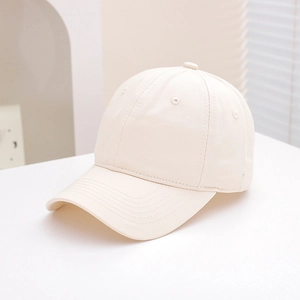 Detail of minimalist cream cotton baseball cap showing stitching and six-panel crown structure