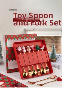 Macro view of Christmas gift box containing golden stainless steel spoons and forks