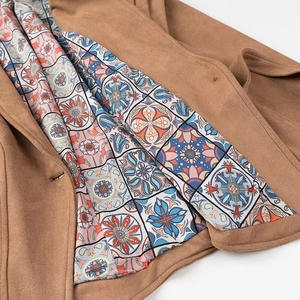 Close-up of suede biker jacket featuring a decorative geometric tile pattern lining