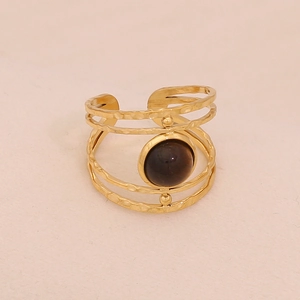 Detail of four-layer gold hammered ring featuring a round tiger eye natural stone