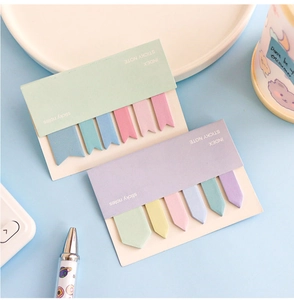 Flat lay of macaron gradient index sticky notes on blue desk with cute stationery
