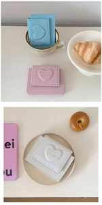 Detail of macaron color PU leather wallets with heart embroidery and lychee texture