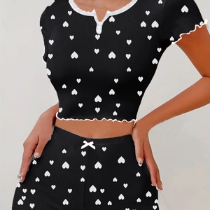 Women's black two-piece pajama set with white heart print and lace V-neck top