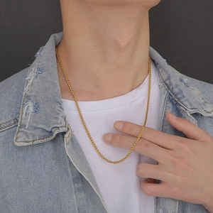 Golden stainless steel keel chain necklace for men and women worn on a model