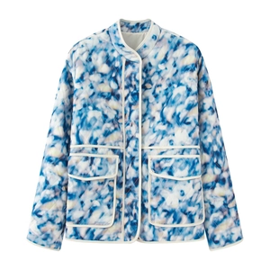 Detail of floral quilted jacket with stand collar, large front pockets and white piping