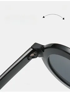 Close-up of durable silver metal hinges on black round frame stylish sunglasses