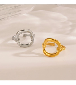 Detailed view of minimalist open rings with hollow geometric patterns in gold and silver