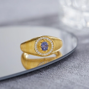 Vintage S925 sterling silver ring with oval tanzanite and diamonds on a mirror tray