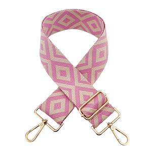 Detail of pink and beige diamond pattern woven strap with gold metal lobster clasps