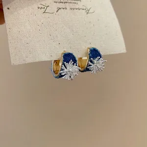 Denim C-shaped hoop earrings with gold finish and silver starburst details