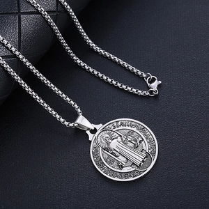 Silver Saint Benedict medallion pendant with box chain on black leather background