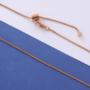 Close-up of adjustable rose gold box chain with slide clasp and lobster claw closure