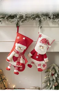 Christmas stockings featuring Santa and Snowman hanging on a fireplace with festive lights